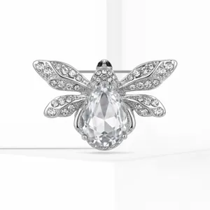 Detailed shot of silver tone bee brooch with crystal rhinestones and pear cut center stone.
