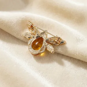 Exquisite gold tone alloy bee brooch back detail, elegant crystal insect jewelry pin for women.