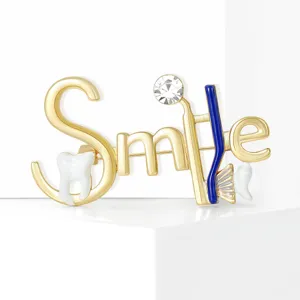 Detailed view of creative enamel letter tooth brooch, lovely dental themed lapel pin accessory.