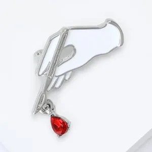 Medical series scalpel enamel brooch featuring a white hand and red drop pendant for apparel.