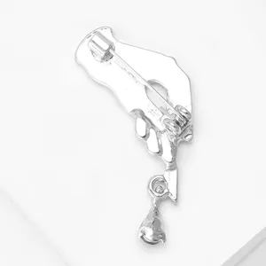 Close-up detail shot of the silver metal brooch back showing secure pin clasp and metal structure.