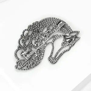 Detailed view of the back of a vintage silver hollow horse brooch, showing pin mechanism.