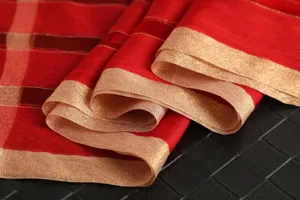 Detailed view of a luxurious red and gold striped silk wool blend scarf for women's fashion.