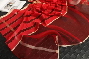 Silk wool blend red scarf with gold stripes, elegant winter fashion shawl for women detail view.