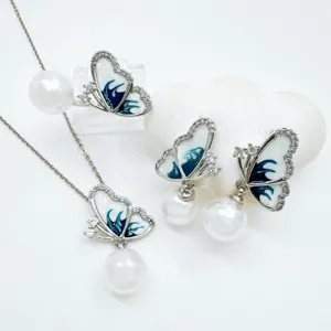 Detailed close-up of the elegant butterfly and pearl jewelry set showcasing exquisite enamel.