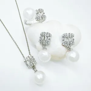 Close-up detail of luxury pearl and zircon jewelry set, elegant necklace and earrings.
