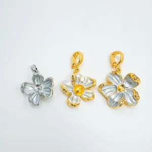 Detail view of exquisite metallic flower pendants, silver and gold two-tone DIY charms.