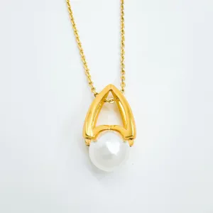 Elegant gold plated pearl pendant necklace detail featuring niche design geometric arch mount.