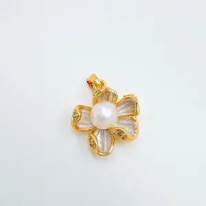 Detailed close-up of the elegant gold-plated pearl flower pendant with sparkling rhinestone details.