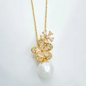 Gold plated flower pearl pendant necklace detailed view, elegant fashion jewelry accessory.