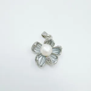 Charming pearl flower pendant necklace detail, elegant silver tone metal with sparkling cubic zirconia.