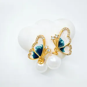 Exquisite butterfly pearl earrings detail, gold-plated delicate design, elegant jewelry.