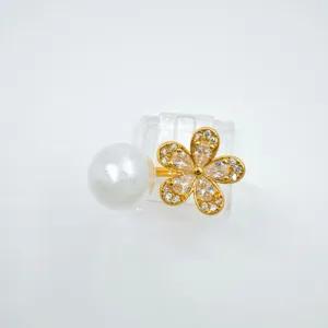 Exquisite pearl flower detail shot featuring sparkling zircon and gold-plated design.