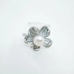 Silver tone pearl flower ring with sparkling zircon details elegant jewelry accessory detail shot