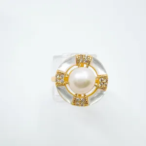 Exquisite geometric pearl ring featuring mother-of-pearl and sparkling zircon in fine gold detail.