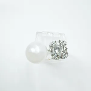 Elegant pearl and baguette zirconia cluster ring fashion jewelry detail display shot