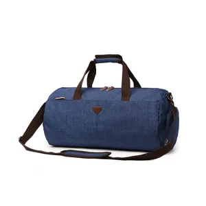 Blue water-repellent travel duffel bag with shoulder strap and shoe compartment design.