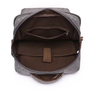 Zaino grigio impermeabile con scomparto per laptop e tasca interna con cerniera per viaggi.