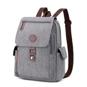 Waterproof canvas casual backpack for travel and daily use, grey school bag with brown straps.