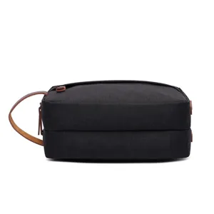 Borsa da toilette nera in tela da viaggio, marsupio per cosmetici portatile con manico in pelle.