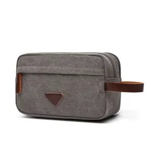 Borsa da toeletta in tela grigia con dettagli in pelle marrone, organizer per trucco portatile.