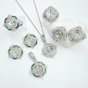Detailed view of DIY jewelry setting components with cubic zirconia and natural shell details.