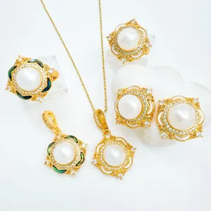 Elegant gold pearl jewelry set including necklace rings and earrings with sparkling crystals.