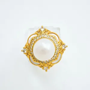 Close-up of gold plated pearl clover ring with micro inlaid cubic zirconia details for women.