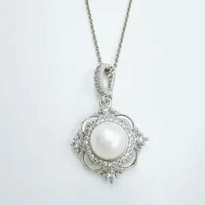 Elegant silver pearl pendant necklace with sparkling cubic zirconia and chic quatrefoil design.