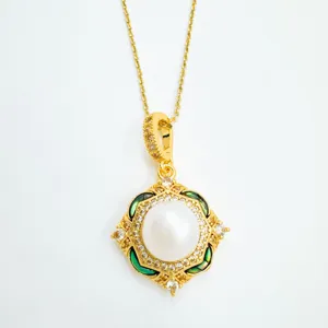 Exquisite gold-plated pearl pendant necklace with dazzling micro-set rhinestones and green details.