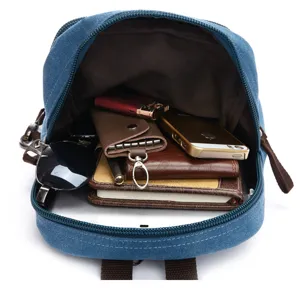 Blue canvas backpack interior showing large capacity for tablet and daily travel essentials.