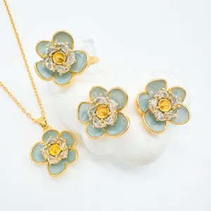 Gold plated floral necklace earrings ring set detail view featuring crystal flower accents.