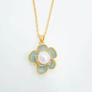 Exquisite gold-plated necklace featuring a white pearl and blue camellia flower pendant detail.