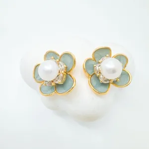 Exquisite camellia flower stud earrings featuring natural freshwater pearls and mint green petals.