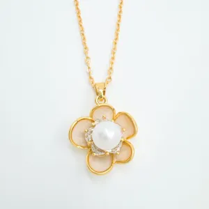 Camellia pendant necklace detail shot featuring central pearl and gold plated chain design.