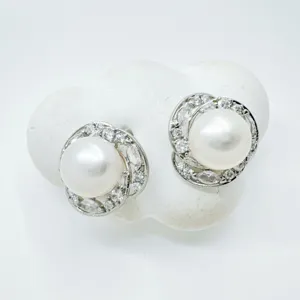 Elegant pearl stud earrings with sparkling cubic zirconia halo, perfect for daily wear.