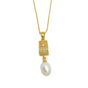 Gold plated pendant necklace featuring a curved pavé rhinestone element and a pearl.