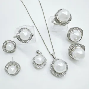 Elegant pearl jewelry set with sparkling zircon halo, necklace, earrings, and rings.