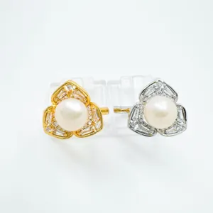 Detail shot of pearl and cubic zirconia rings with elegant clover design, dual color set.