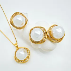 Detailed view of vintage gold plated geometric pearl necklace and matching crystal earrings set.