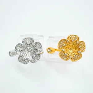Close-up of exquisite four-petal flower zircon rings in silver and gold, premium metal.