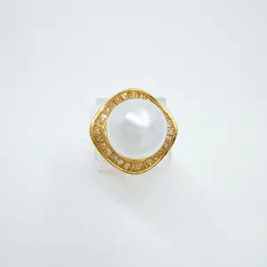 Detail shot of the elegant gold plated pearl pendant mounting, featuring a geometric sparkling frame.