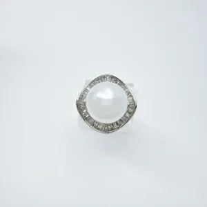 Vintage pearl pendant with geometric diamond halo, elegant fashion jewelry accessory.
