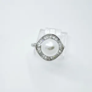 Detailed view of the vintage geometric pearl ring adorned with sparkling side stones, elegant.