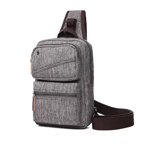 Stylish grey canvas sling bag for men and women, casual crossbody chest bag with multiple pockets.