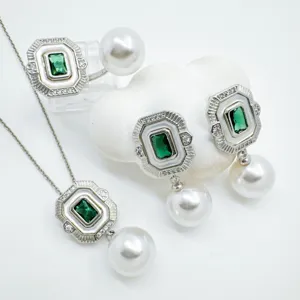 Detailed view of vintage retro emerald green rectangular pearl pendant earrings ring set jewelry.