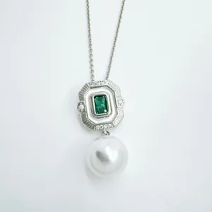 Vintage rectangular green stone pearl pendant necklace jewelry detail view with silver chain.