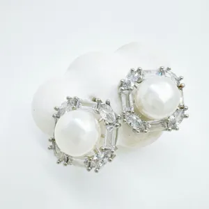 Detailed close-up of geometric square pearl earrings with sparkling crystal rhinestones.