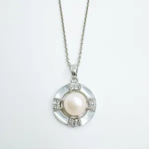 Geometric pearl pendant necklace detail showcasing shimmering mother of pearl and delicate cz stones.