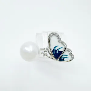 Exquisite pearl butterfly pendant necklace with blue enamel and sparkling zirconia stones.